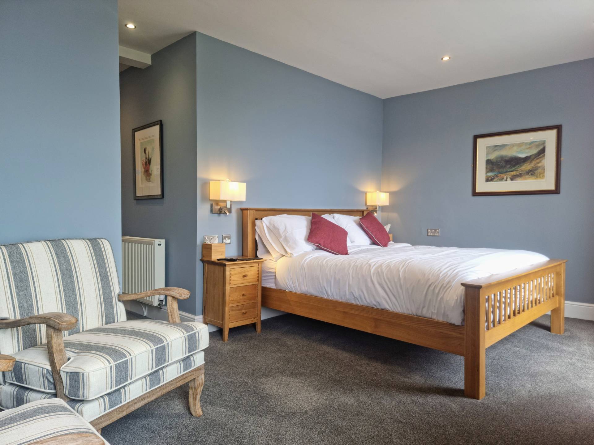 Sea-facing bedroom with two windows, super king bed and seating area in Room 103.