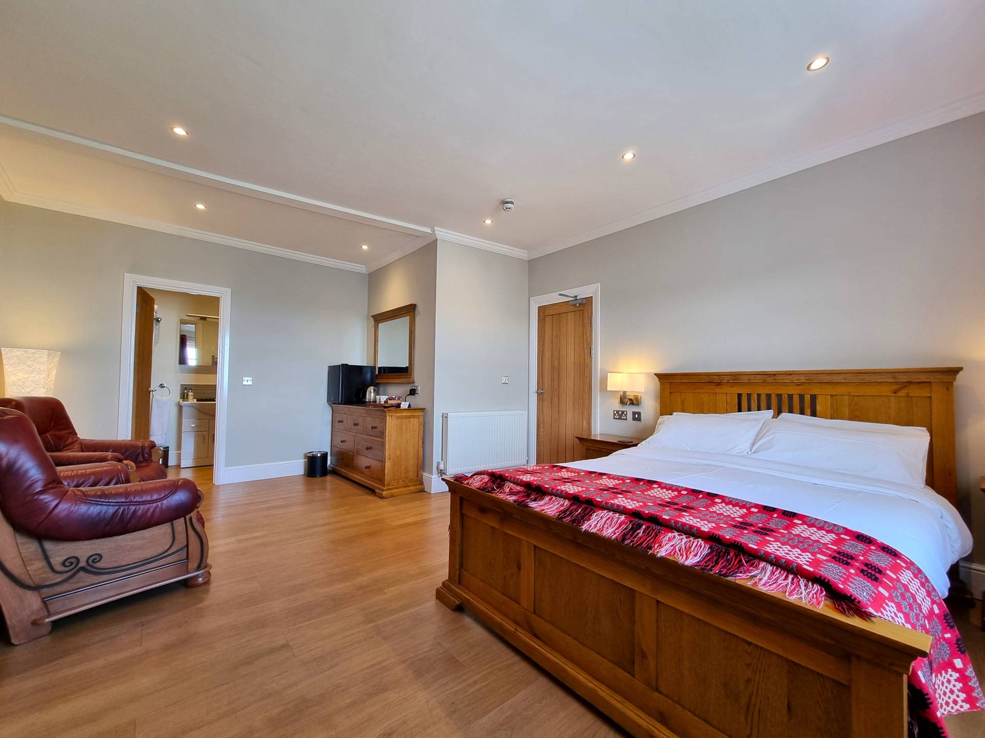 Luxury king double room at Min y Don Llandudno with panoramic sea views, king-sized bed, en-suite shower, and modern amenities.