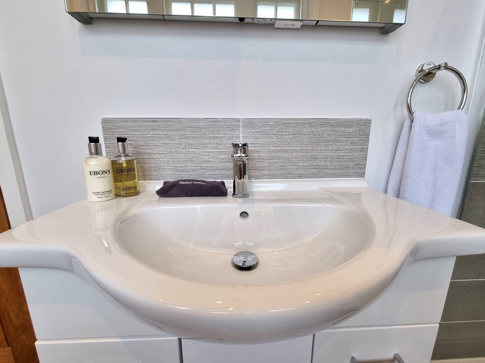 Vanity unit in Suite 201 at Min y Don Llandudno with makeup remover cloth and complimentary Ebony hand and body wash and moisturiser.